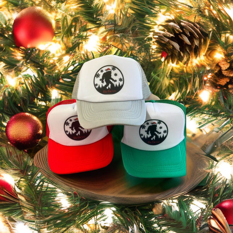 Holiday Sasquatch Believe Trucker Hats