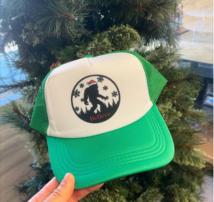 Holiday Sasquatch Believe Trucker Hats