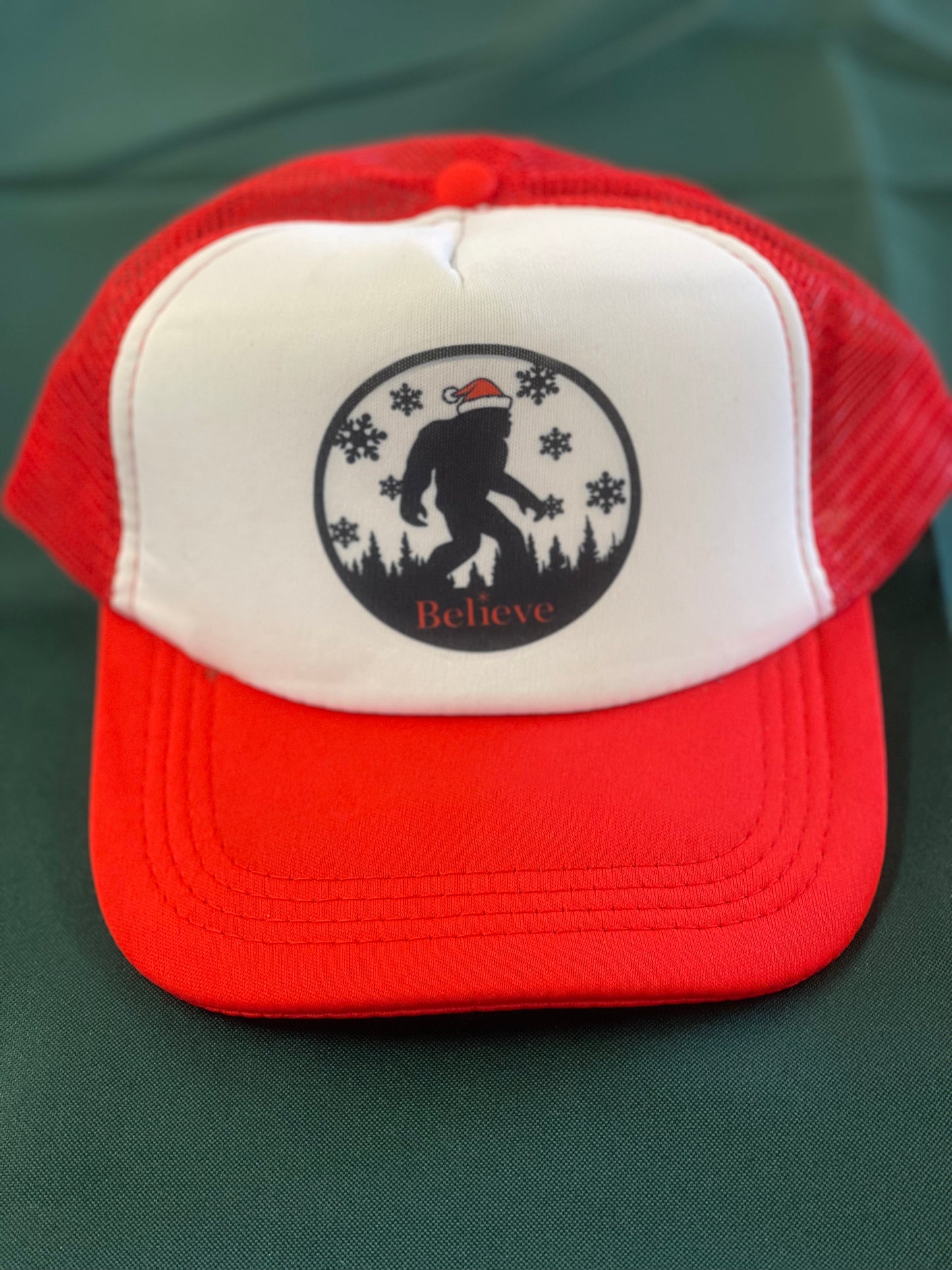 Holiday Sasquatch Believe Trucker Hats