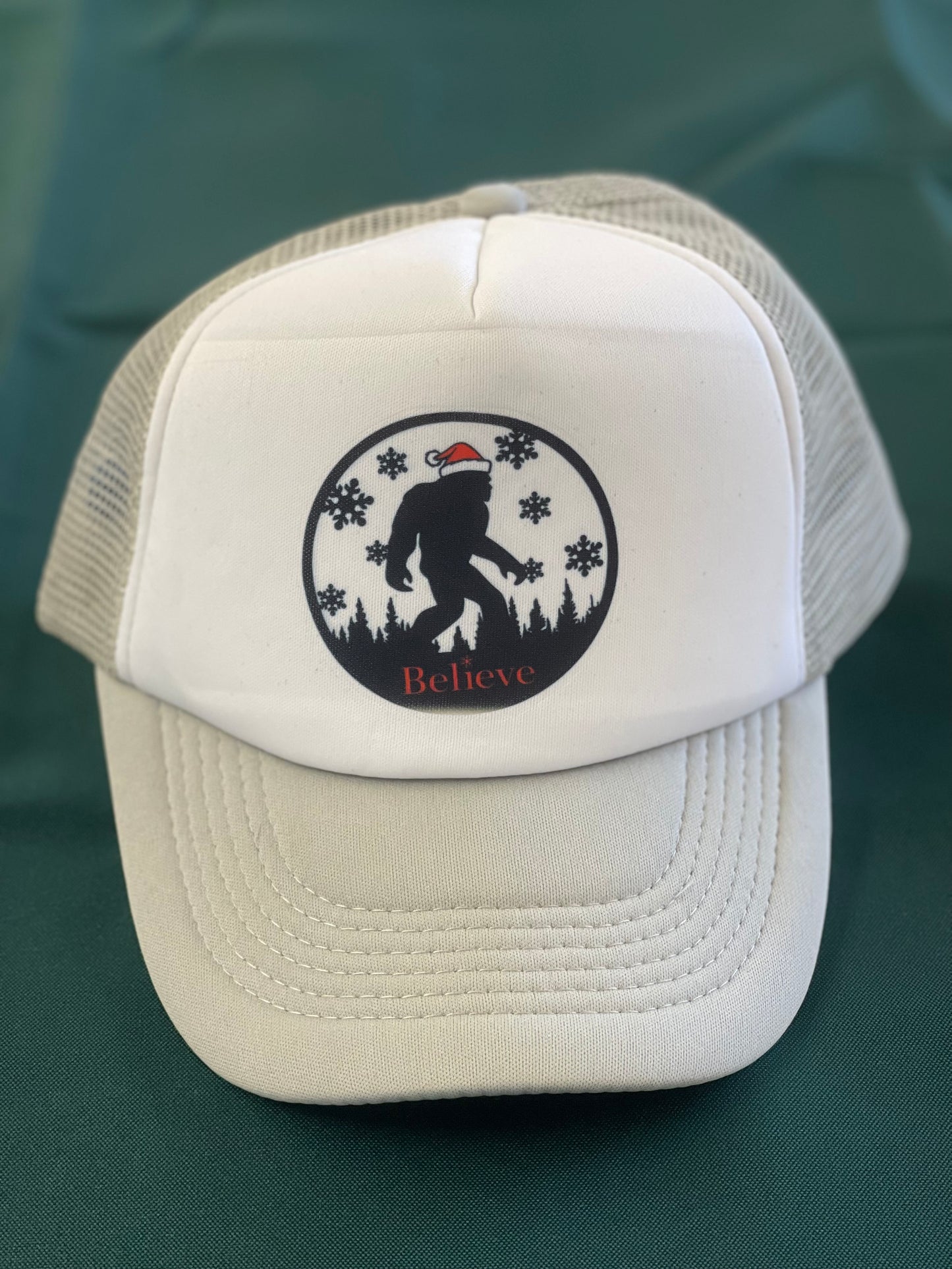 Holiday Sasquatch Believe Trucker Hats